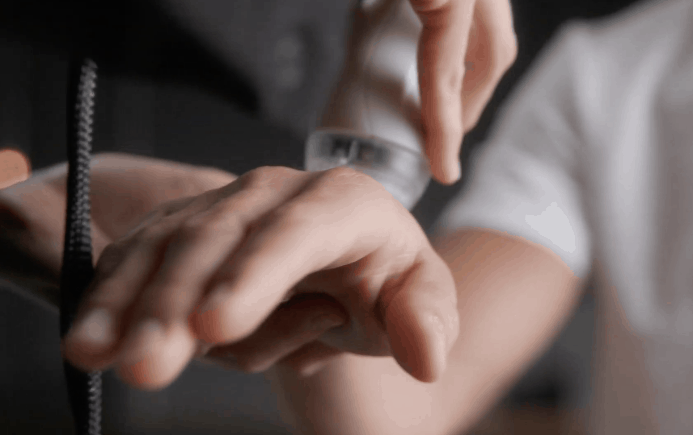 A practitioner using a cold laser to treat a patient's hand pain